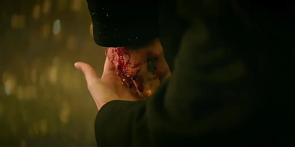 Hong Hae-in holds Baek Hyun-woo's bloodied hands after the vehicle fire