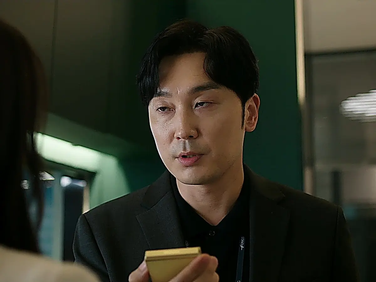 Gong Eun-tae wearing a dark tailored suit jacket over a dark knit collared polo
